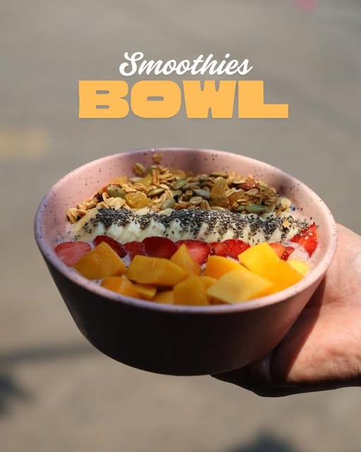 Smoothie bowl with granola, banana, strawberry and mango